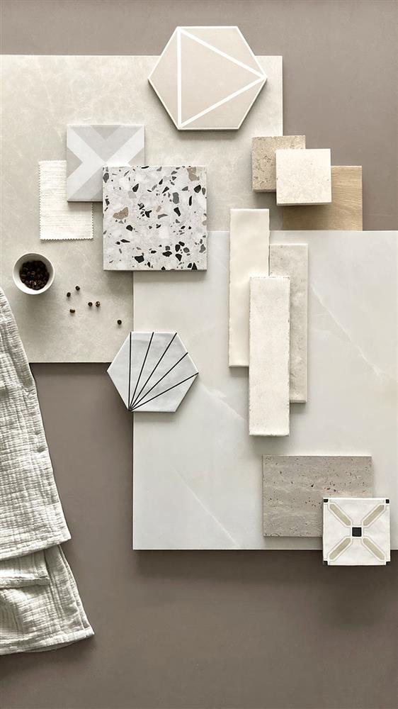 A sample set of geo mocha, Chiltern light, Hoxton natural, Dijon limestone, St-Emilion brushed, Milano Bianco, Marlow ivory, onyx Reale, Winchester almond, Cotswold ivory, lily Bianco, veincut Traventino, and Wentworth cross tiles